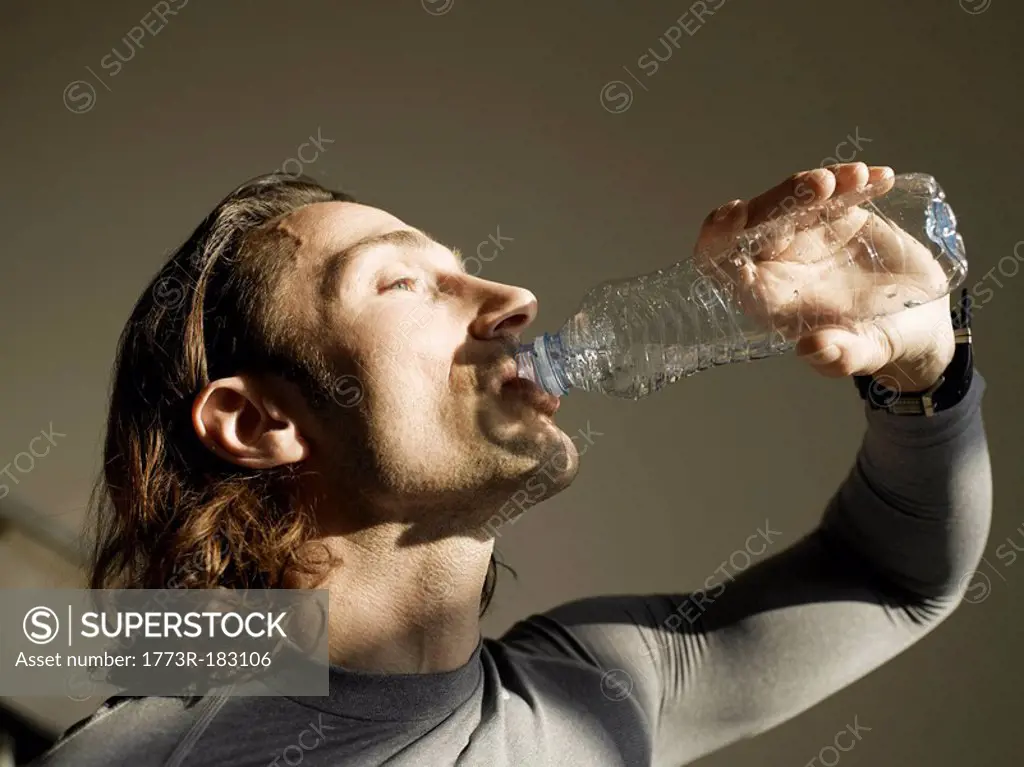 Mature man drinking water, close-up