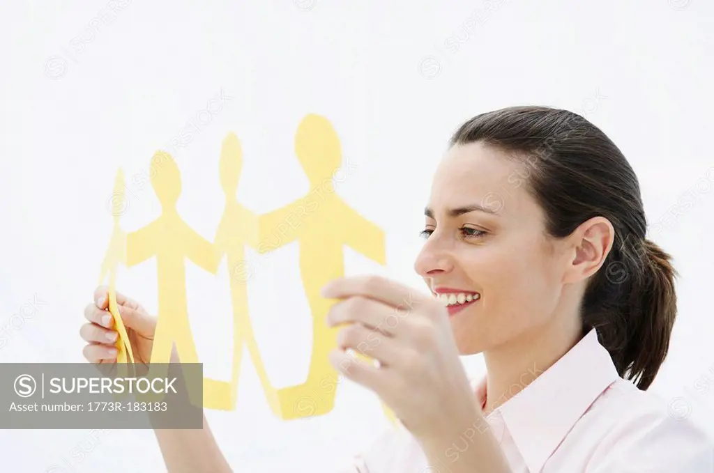 Smiling woman holds paper chain