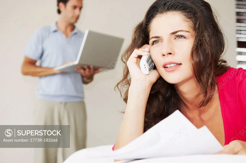 Woman on phone with bills and male