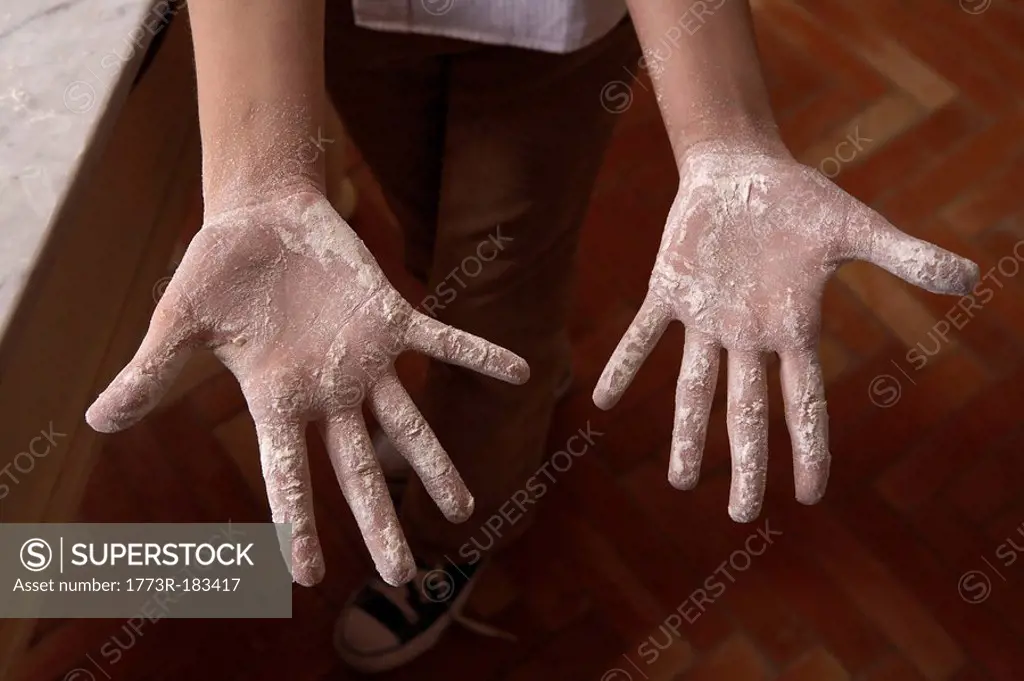 Girls 9-11 hands covered with flour, close-up