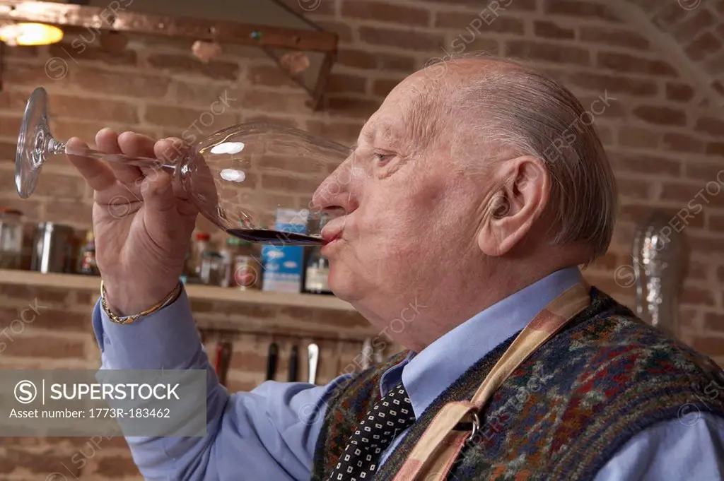 Senior man drinking red wine