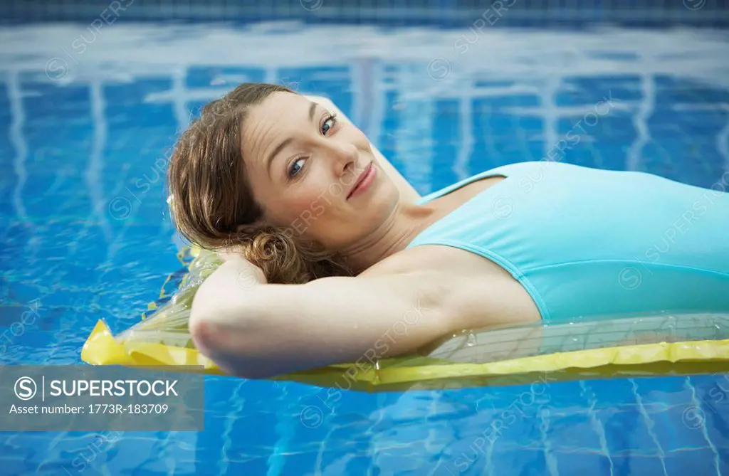 Portrait of woman lying on a lylo