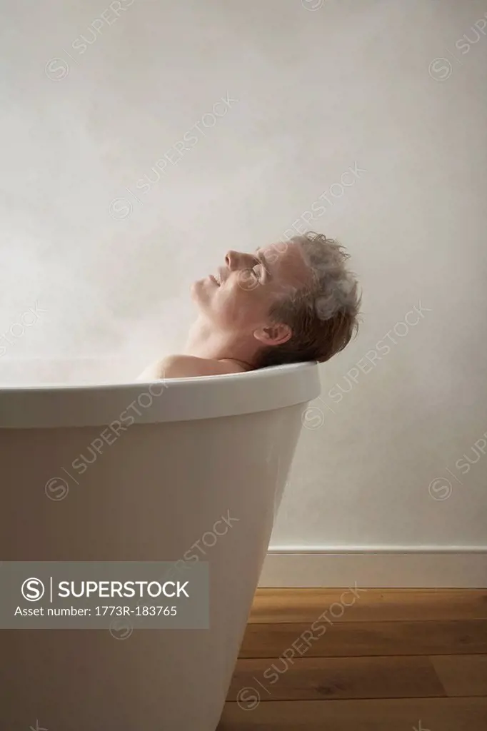 Mans head on edge of bath