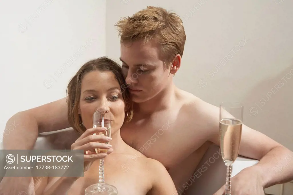 Man and woman drinking in the bath