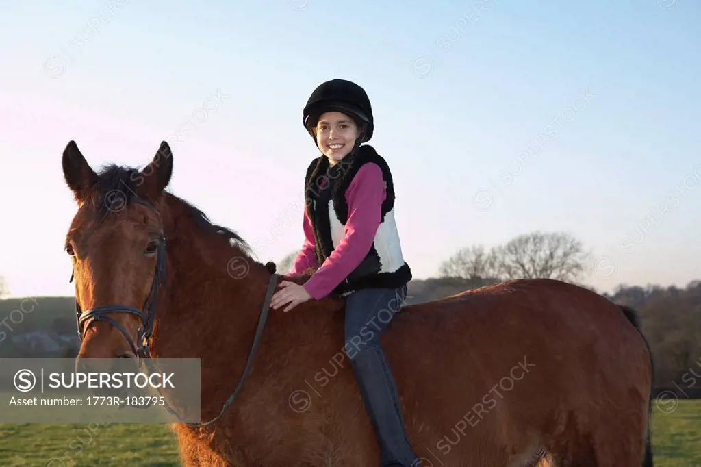 Girl riding her pony