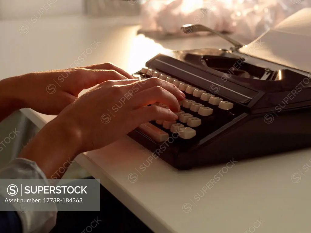 Close up of woman using typewriter