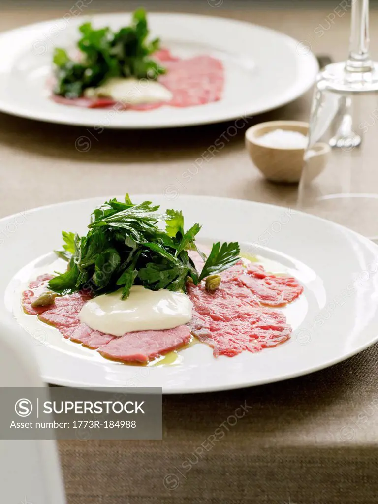 Plate of carpaccio with salad