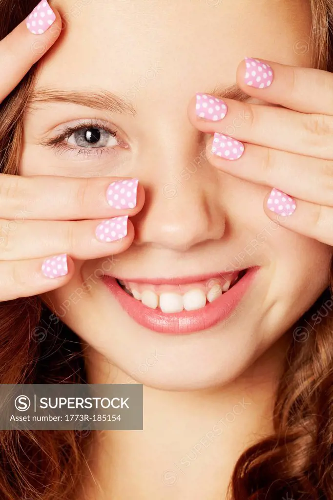 Smiling girl with polka dot manicure