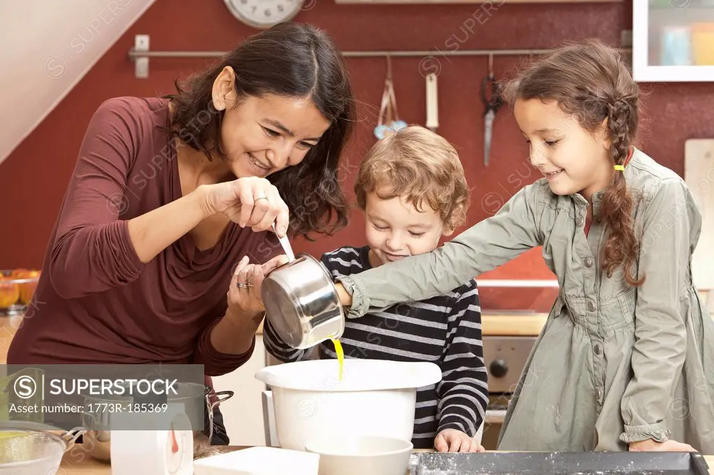 Mother and children cooking in kitchen