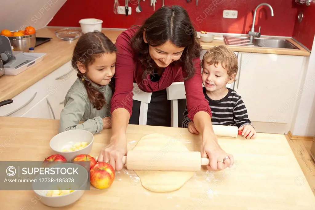 Mother and children baking together