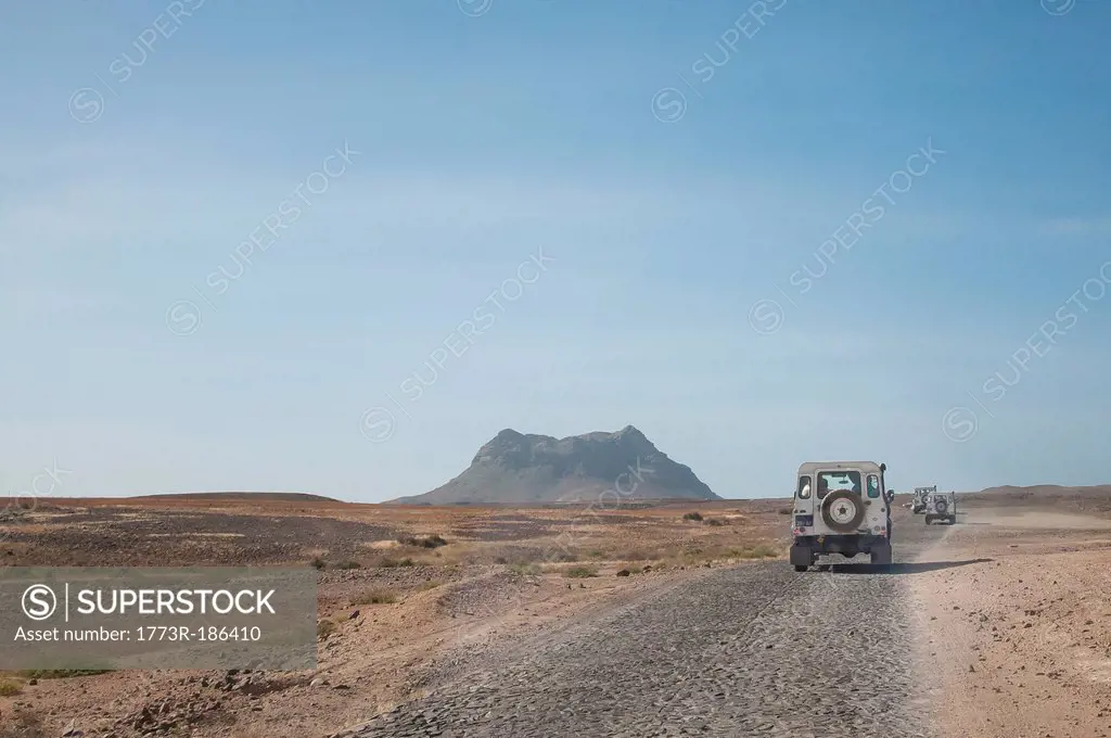 Jeeps driving in dusty landscape