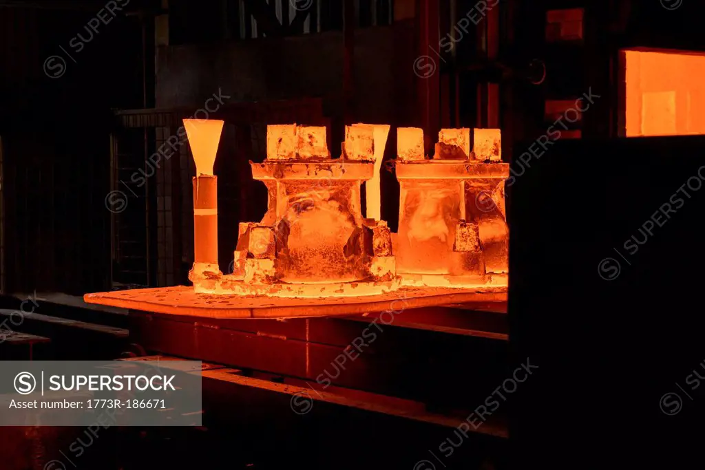 Metal casings glowing in foundry