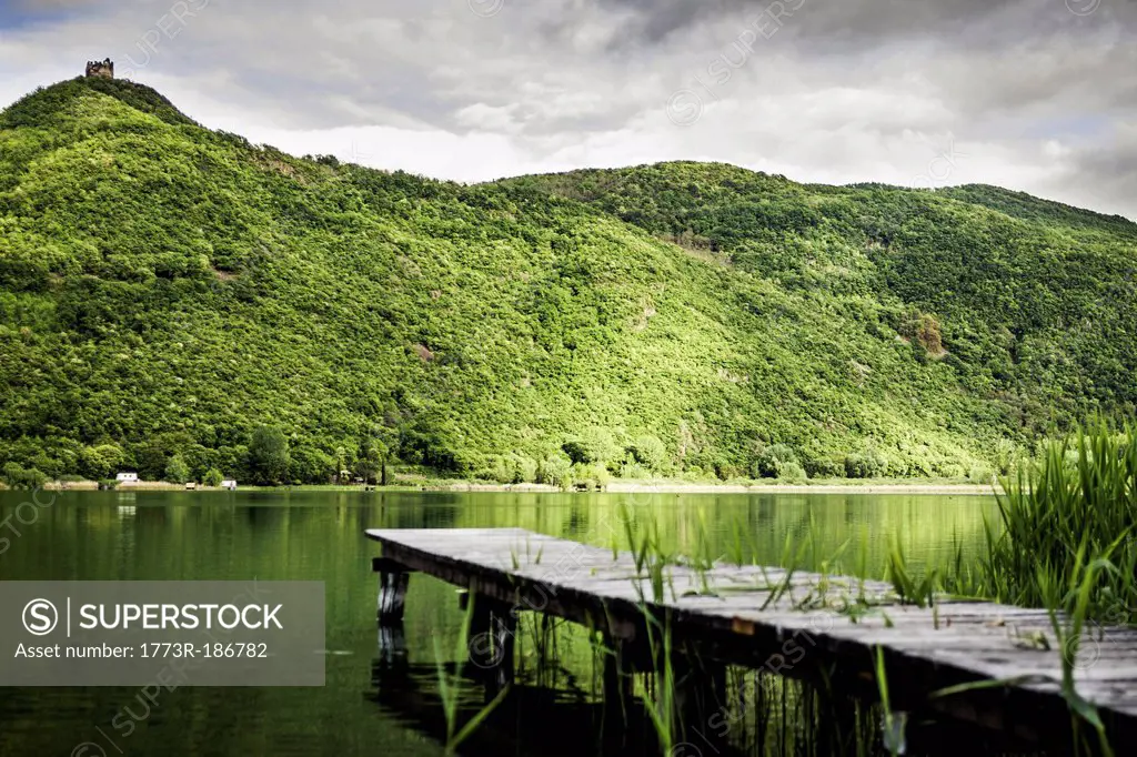 Wooden pier in still rural lake