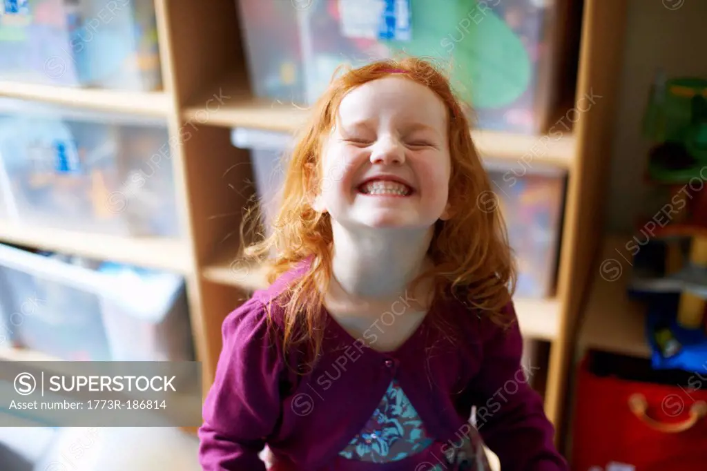 Girl making face in playroom