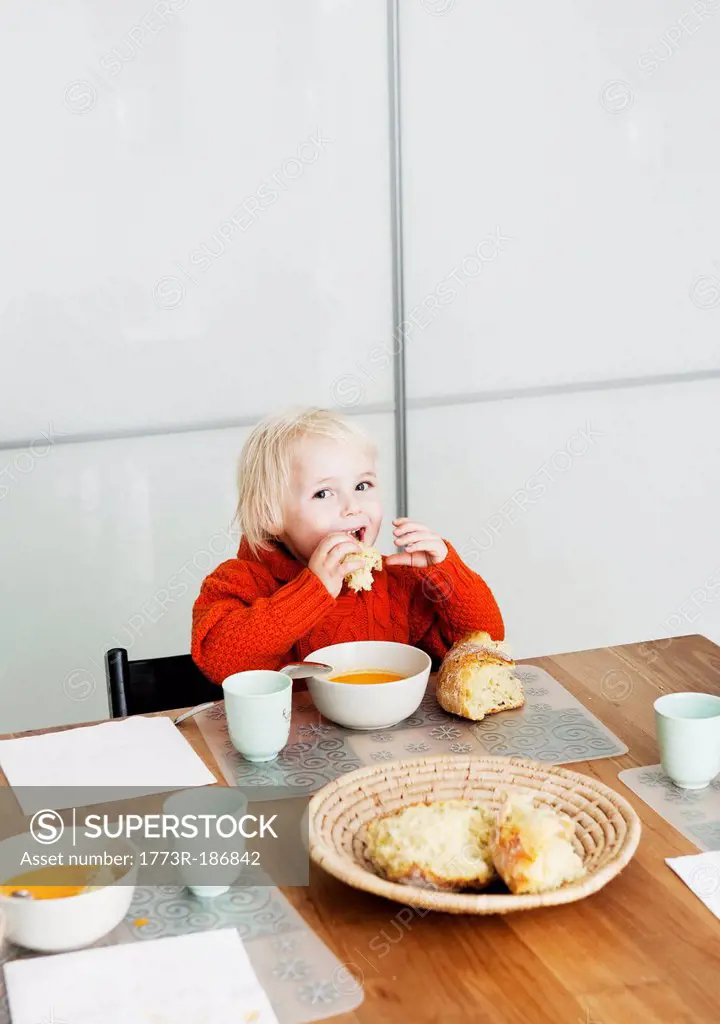 Boy eating lunch at table