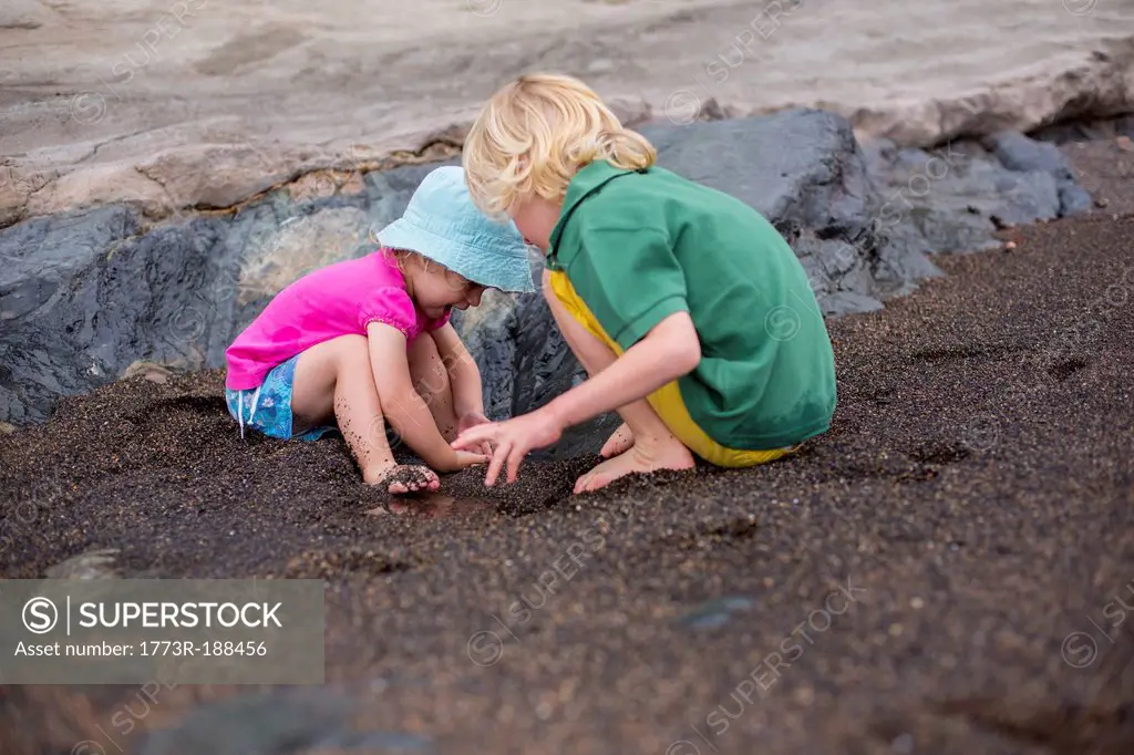 Children playing in sand on beach