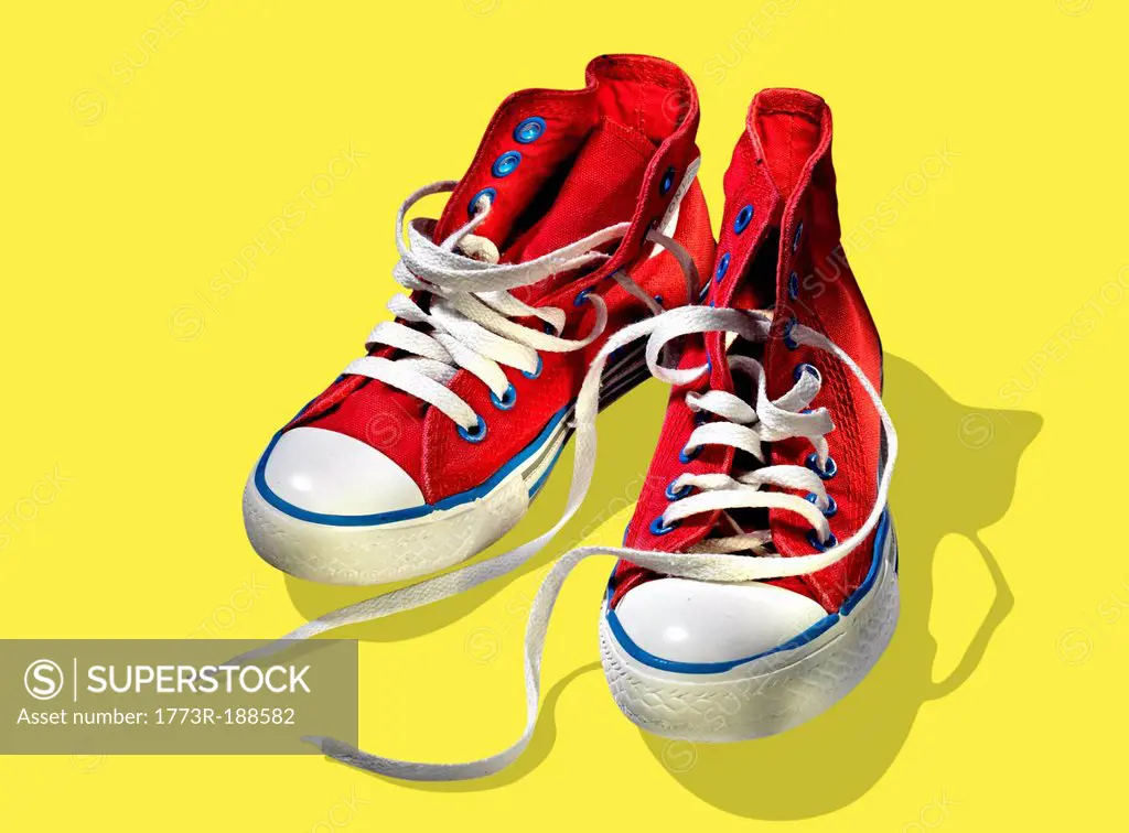Red sneakers on yellow background