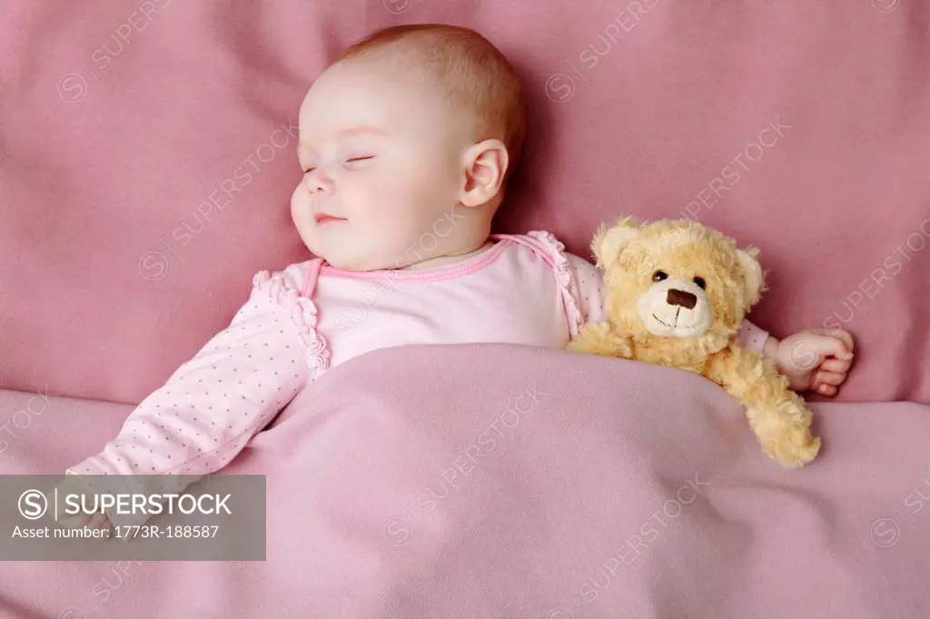 Baby girl sleeping in bed