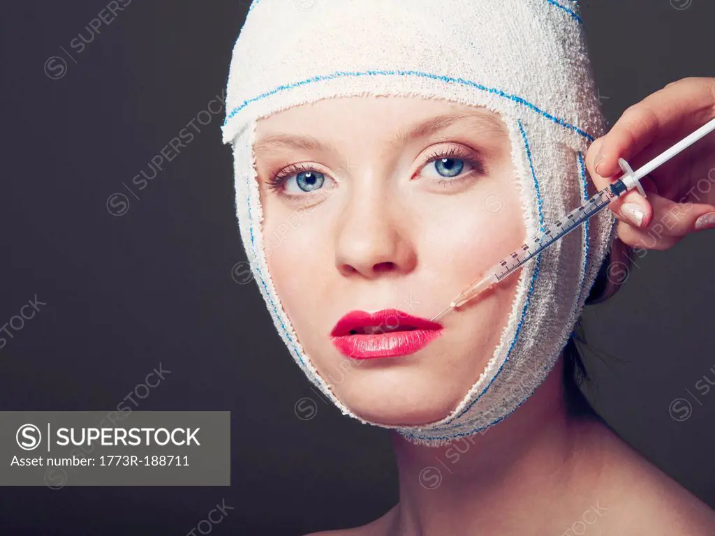 Woman in bandages having injection