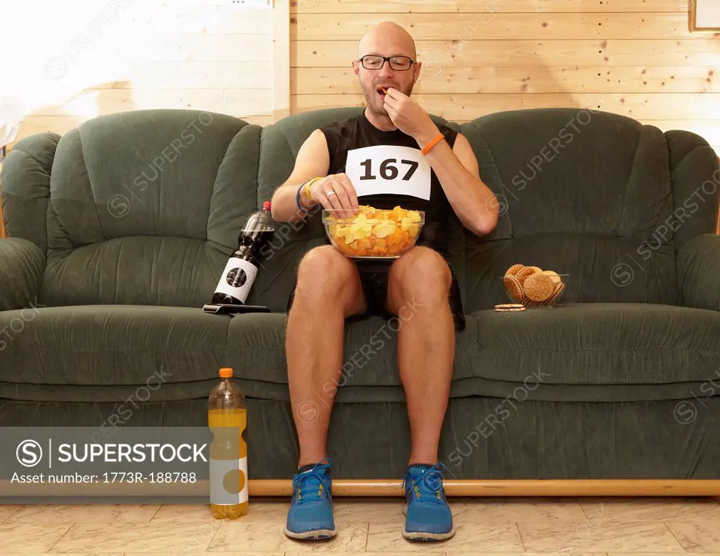 Runner eating chips on sofa