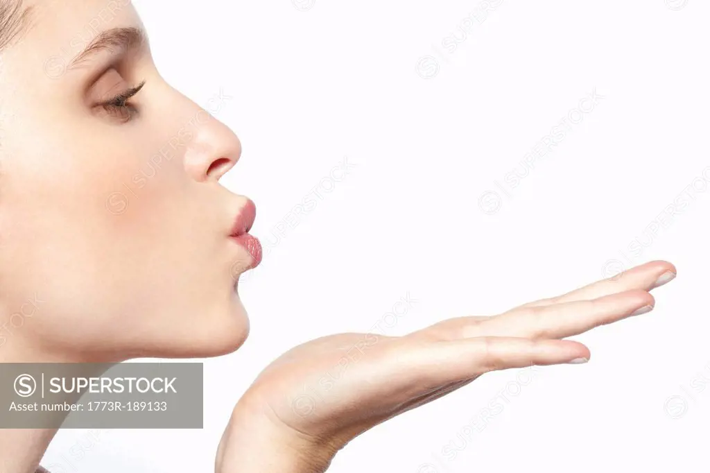 Close up of woman blowing a kiss
