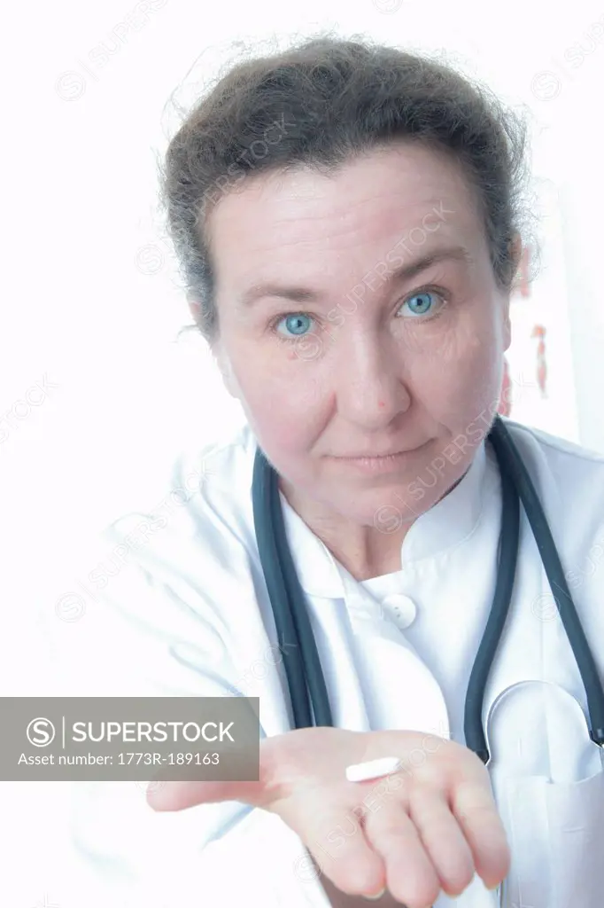 Close up of doctor holding pill