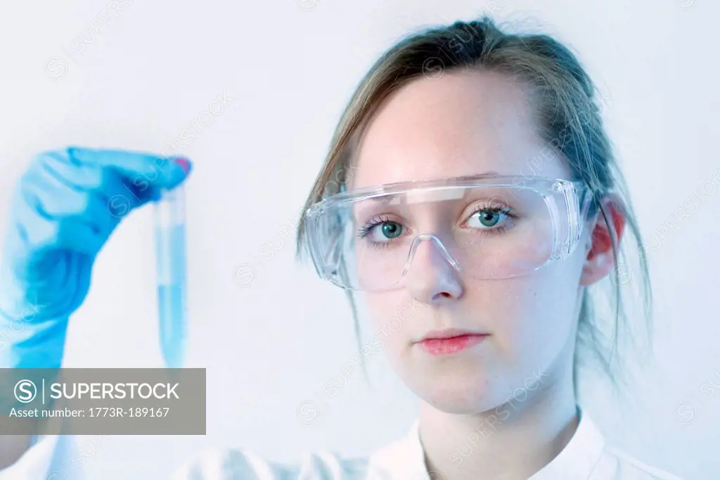 Scientist examining test tube in lab