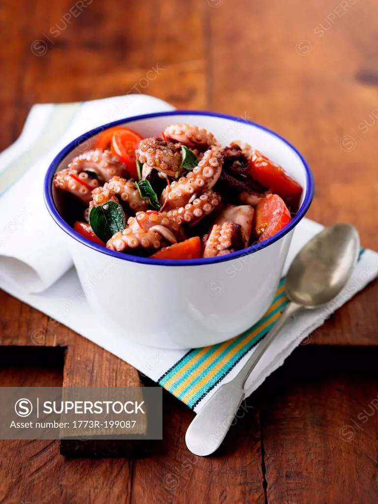 Bowl of octopus with tomatoes and chillies
