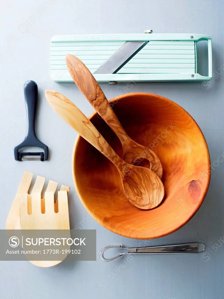 Wooden salad bowl and kitchen utensils