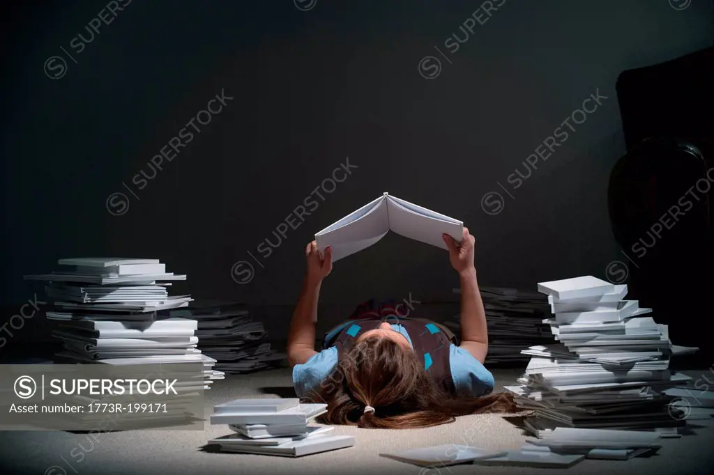 Girl lying on back reading book