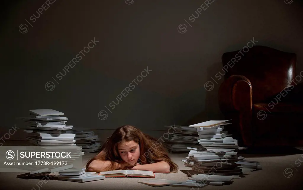 Girl lying on front reading book