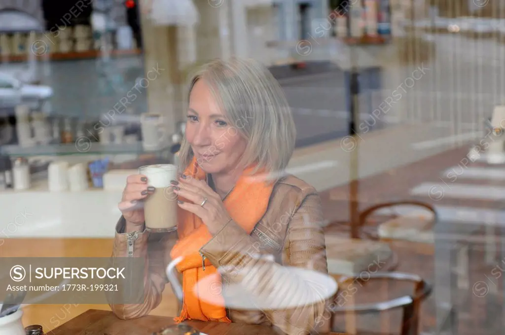 Senior woman sitting on coffee shop