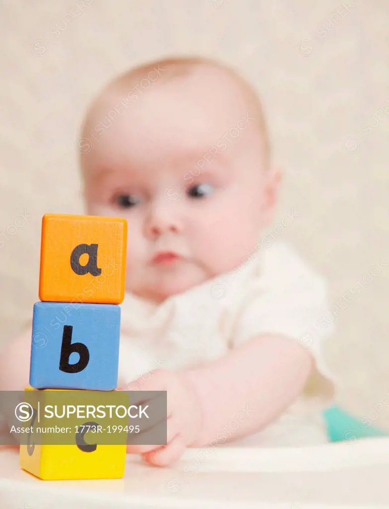Baby girl with alphabet blocks