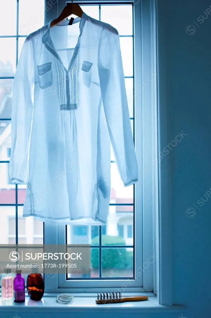 Blouse hanging in window