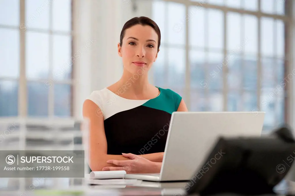 Female office worker using laptop