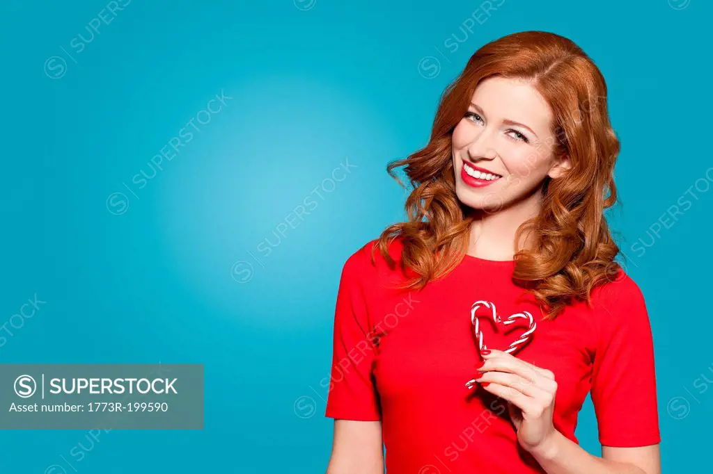 Woman holding heart shaped candy