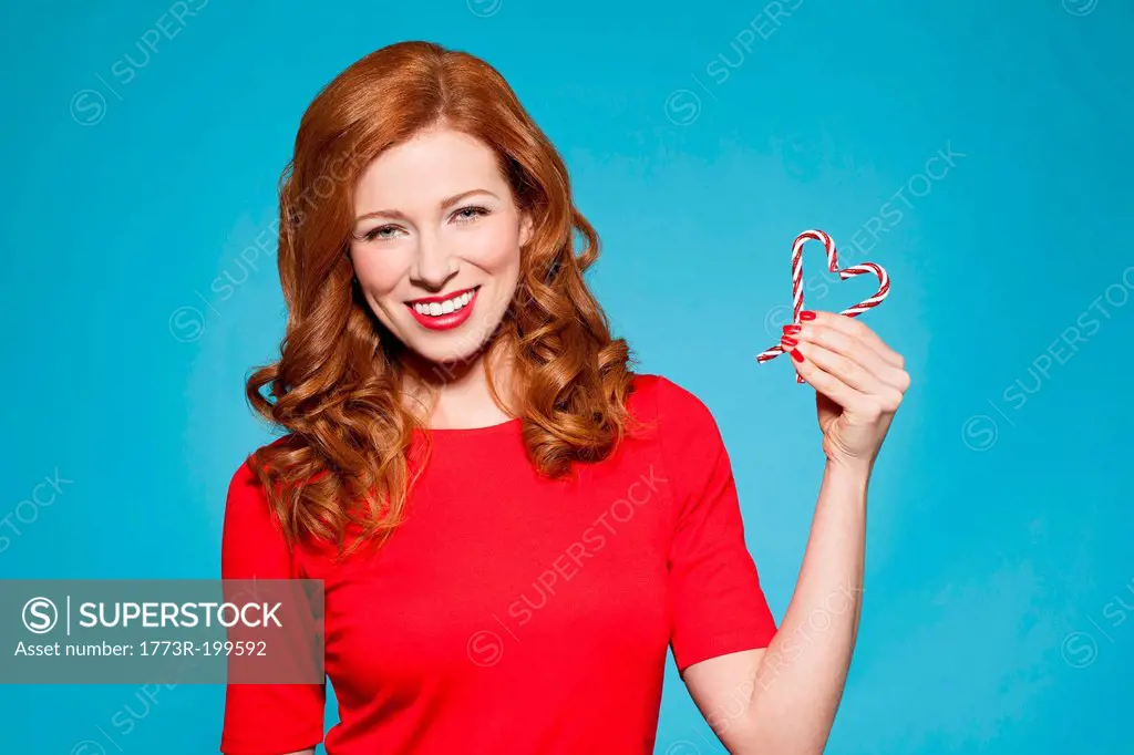 Woman holding heart shaped candy
