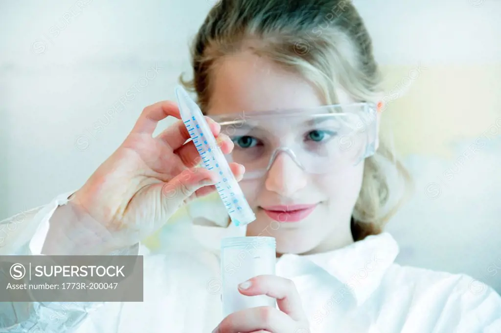 Girl wearing safety goggles doing science experiment