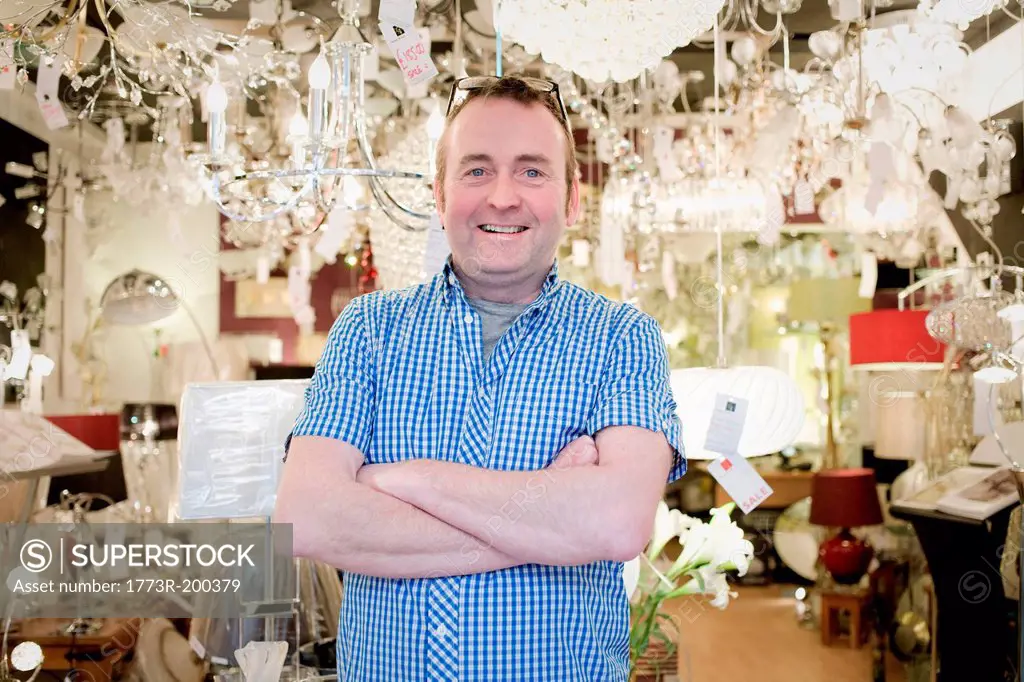 Portrait of mature owner of light store, smiling