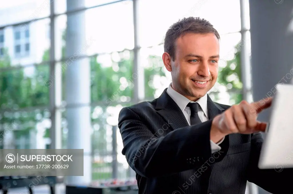 Businessman interacting with digital tablet screen