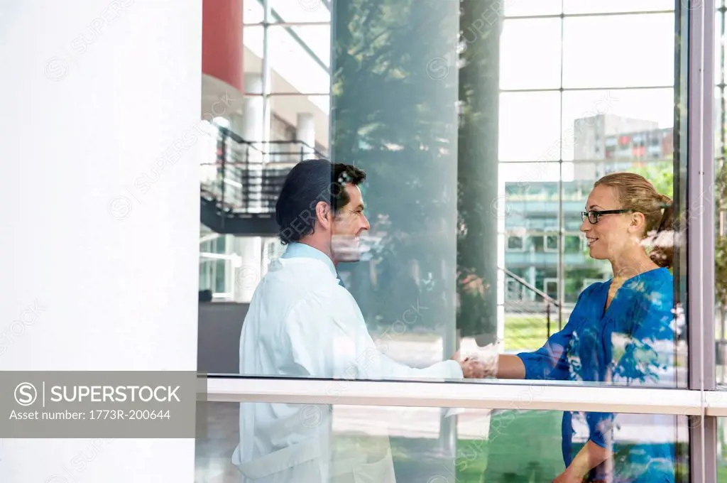 Male doctor meeting female colleague