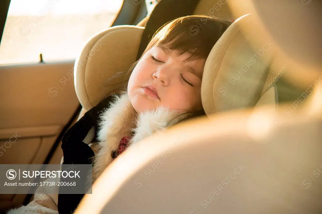 Young girl sleeping in car