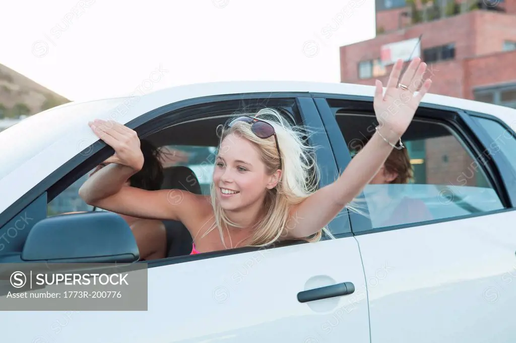 Woman waving through car window