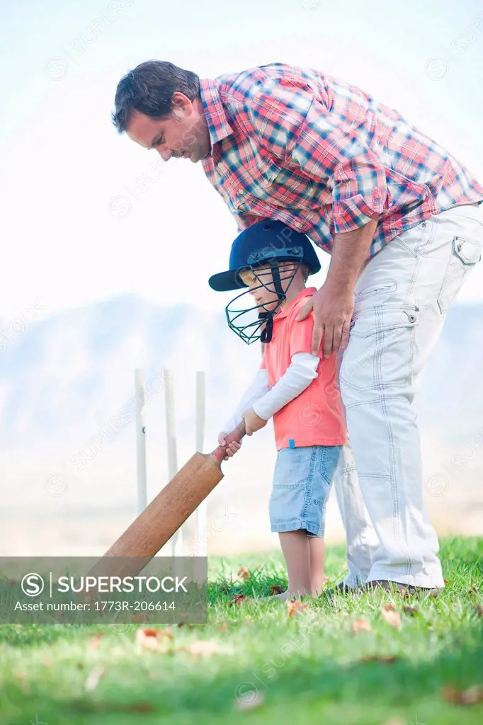 Father and son playing cricket