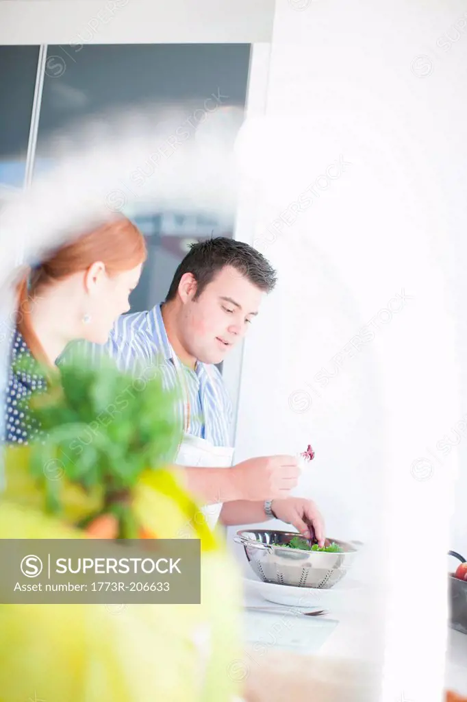 Young man and woman preparing food