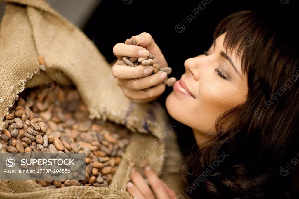 Woman smelling cocoa beans