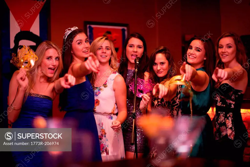 Young women singing in karaoke bar