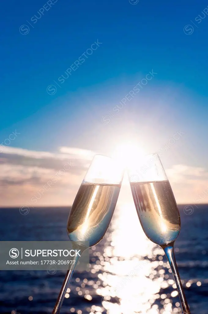 Two wine glasses with sea in background