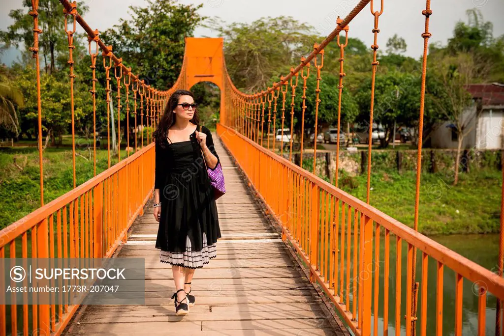 Woman on bridge over river, Vang Vieng, Laos