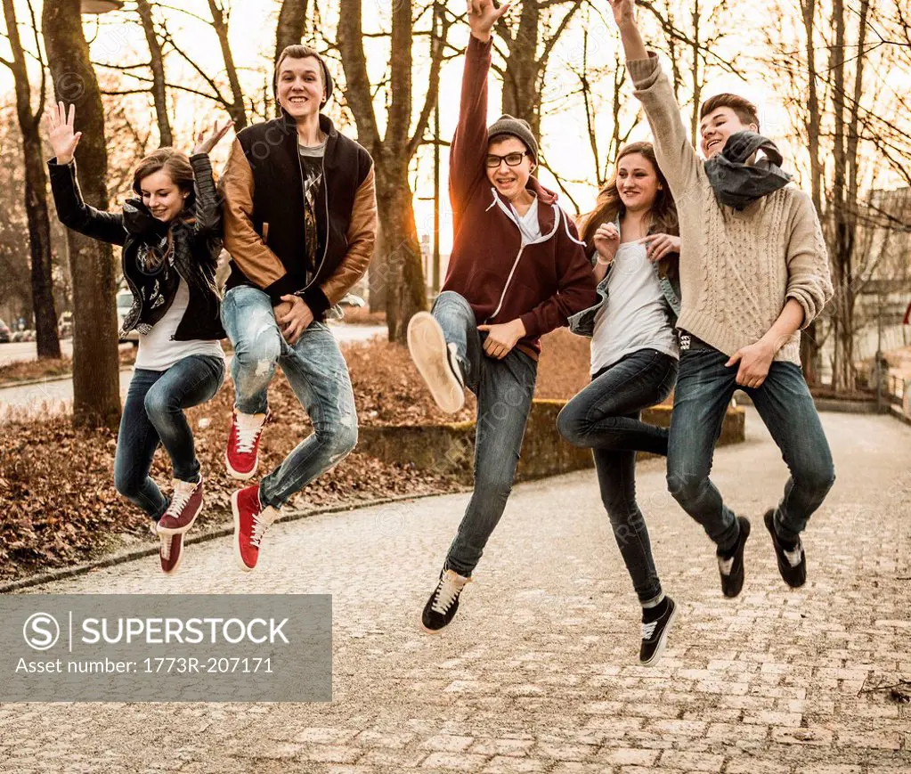 Five teenagers jumping